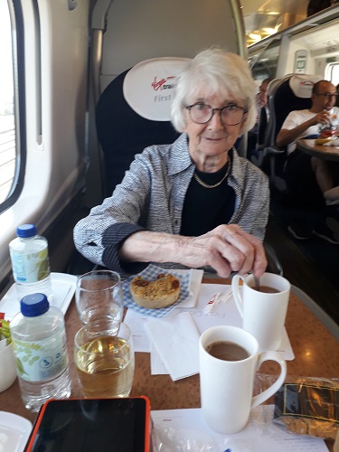 Mum enjoying a drink on the train