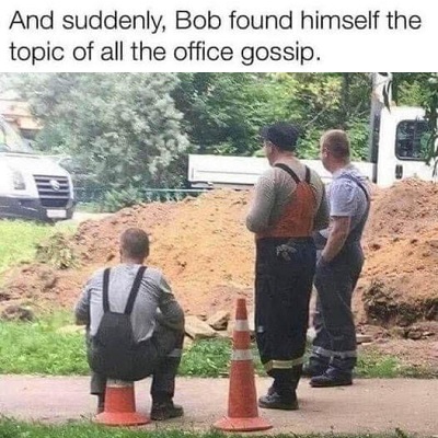 Worker sitting on a traffic cone